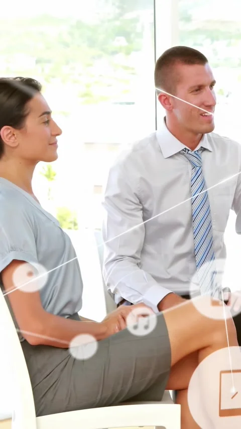 Vertical video: Business pair hearing offscreen speaker holding paper, icons Stock Footage 334547010