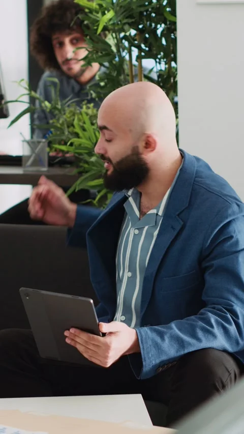 Vertical Video Business team examining reports Stock Footage 243732099