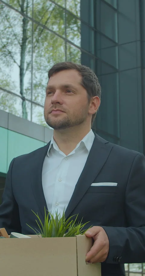 Vertical video. Businessman in despair lost job and walking near office center Stock Footage 345587652