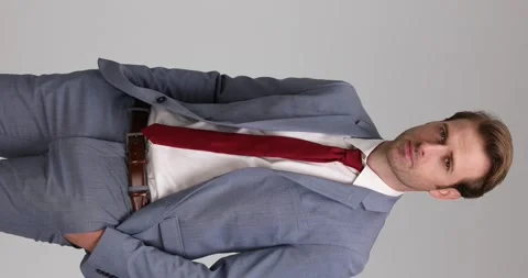 Vertical video with a businessman posing with one hand in pocket, opening his Video stock 154293751