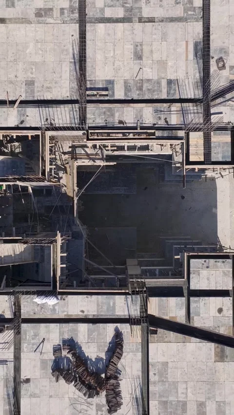 Vertical Video: Busy Construction Area with Metalwork, Facade Installation, and Stock Footage 297750513