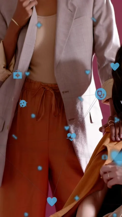 Vertical video: Cam up model fixing blazer showing rust pants while blue icons Stock Footage 333596230