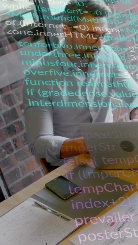 Vertical video: Cam panning up showing man typing on laptop as code overlay Stock Footage 333633077