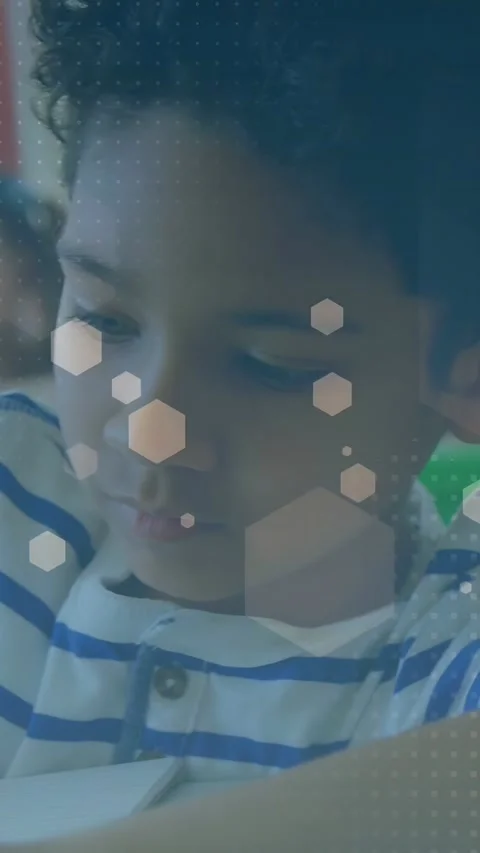 Vertical video: Cam pulling back, boy looking, peer using green tray, hex muting Stock Footage 333542142