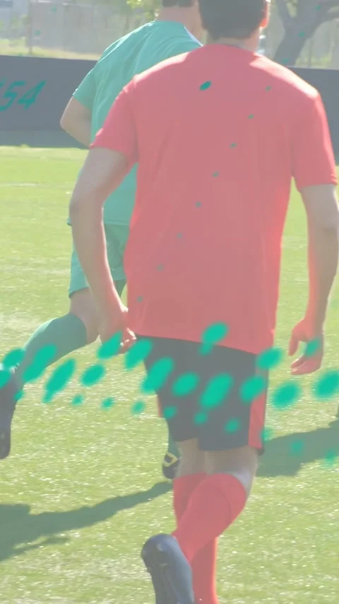 Vertical video: Cam pulling back showing green player running toward goal, teal Stock Footage 340133600