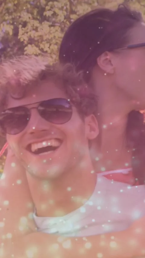 Vertical video: Cam pulling man carrying woman smiling showing travel joy shades Stock Footage 330509941