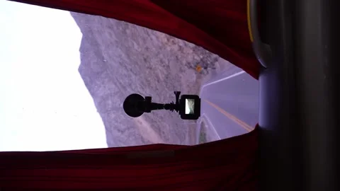 Vertical video of a camera anchored to the windshield of a travel bus in the Stock Footage 164427383