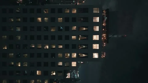 Vertical video, the camera films a modern residential building in a night Stock-Footage 258661820