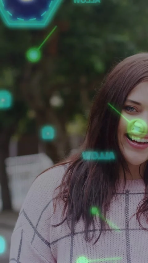 Vertical video: On camera focus woman laughing while AR green nodes passing over Stock Footage 337540967