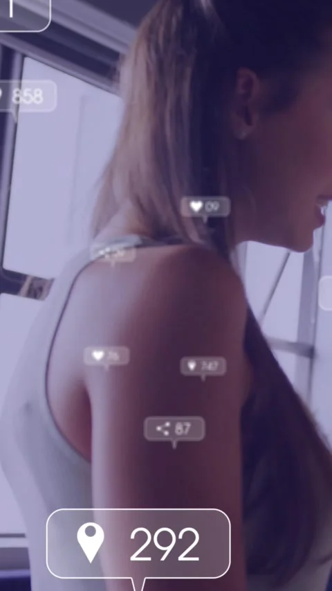 Vertical video: Camera focusing shoulder model turning head while social data Stock Footage 333895669
