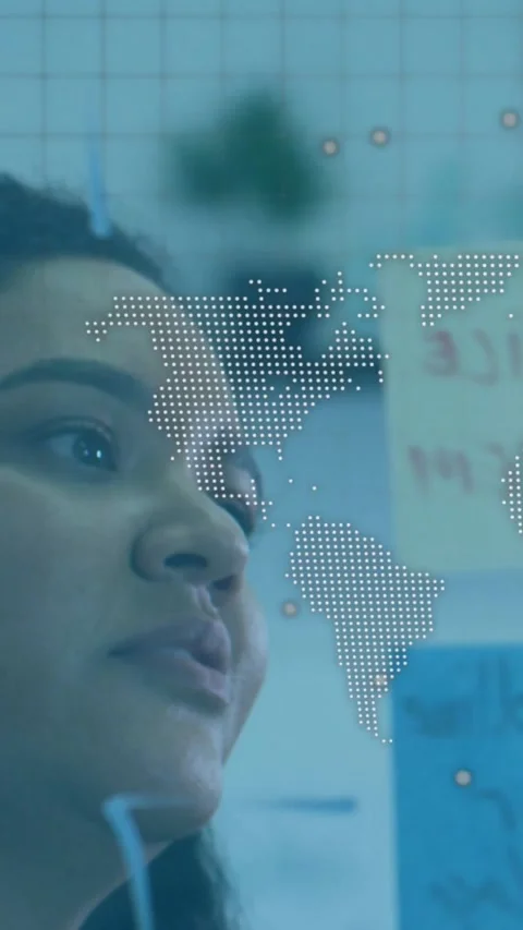 Vertical video: Camera lifting woman at glass board reading notes as map marking Stock Footage 331128571