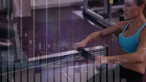 Vertical video: Camera opening on rower, woman rowing with grip, charts Video stock 332772231