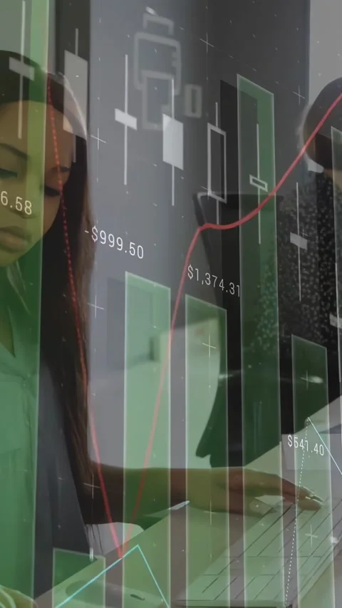 Vertical video: Camera panning desk overlaying finance charts, team typing and Stock Footage 334605105