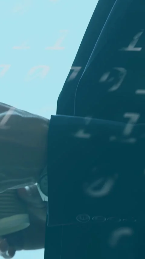 Vertical video: Camera panning down starting man rotating cup projecting binary Stock Footage 333821470