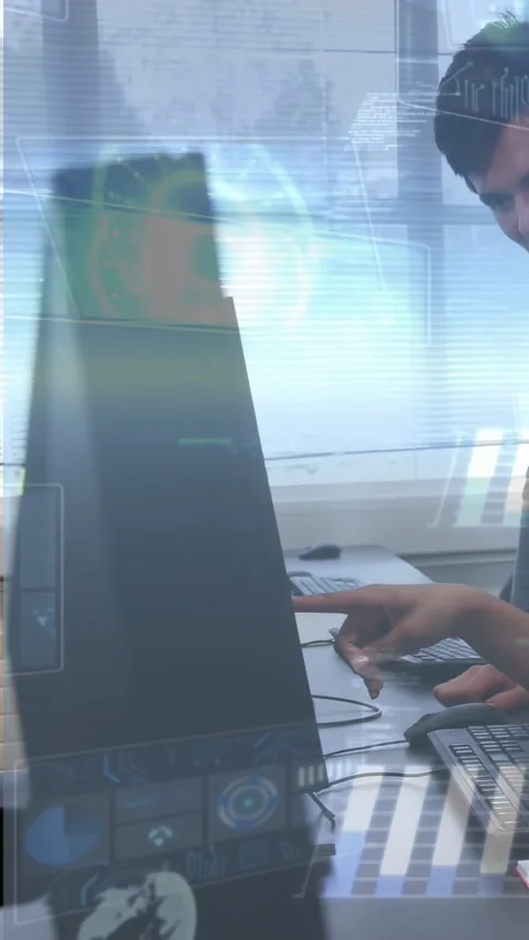 Vertical video: Camera panning, man typing and using mouse for tech work, HUD Stock Footage 334605002