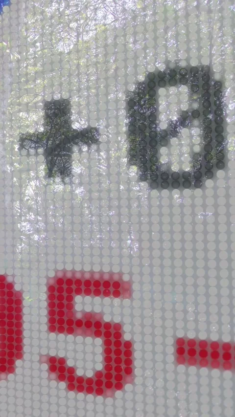 Vertical video: Camera panning over black-red nums after plus focus, showing Stock Footage 333896194
