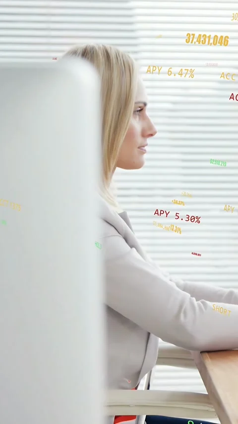 Vertical video: Camera panning revealing monitor, analyst using mouse reviewing Stock Footage 334025102