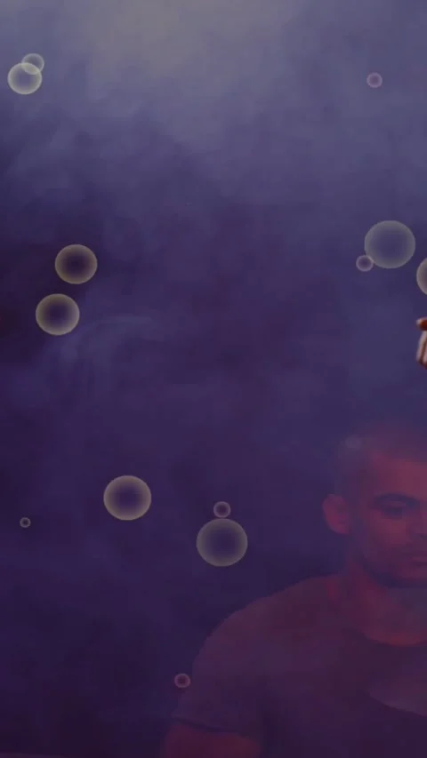 Vertical video: Camera panning revealing band on purple stage with bubbles, Stock Footage 334391960