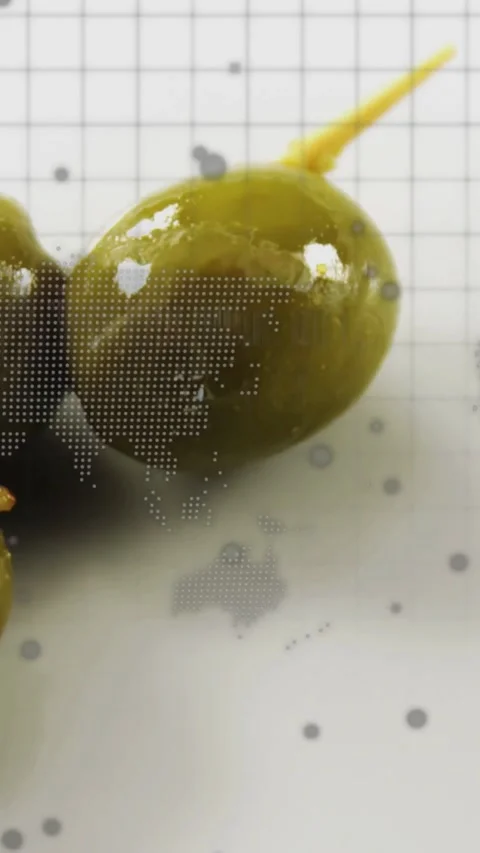 Vertical video: Camera panning revealing green olive on plate, map dots and code Stock Footage 334599081