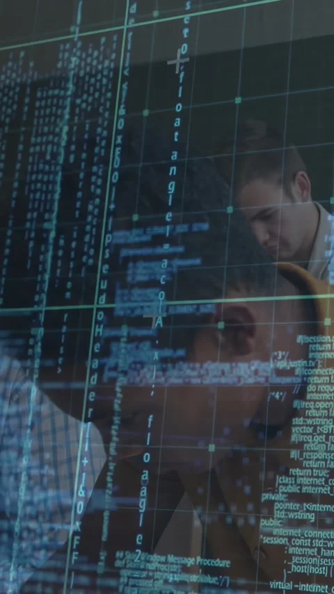 Vertical video: Camera panning right, team leaning over clear screen, teal code Stock Footage 331270972