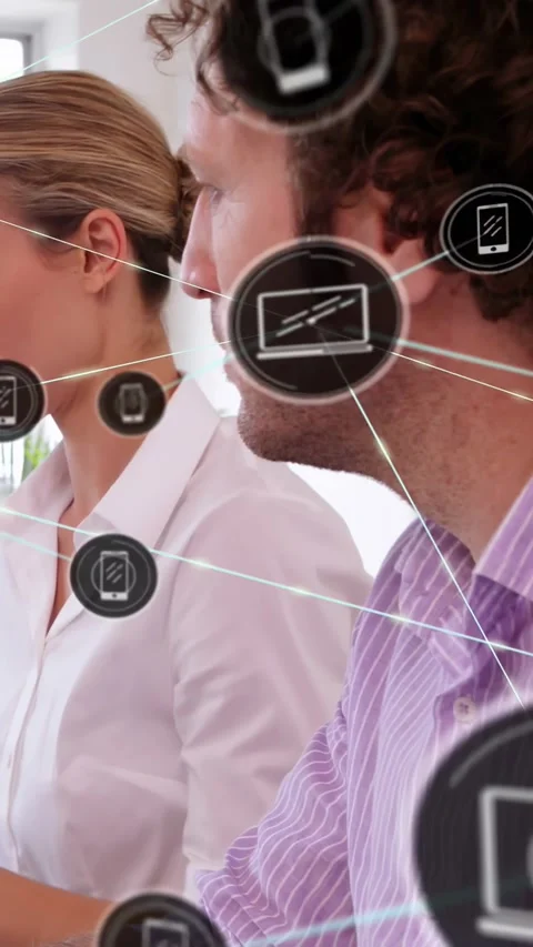 Vertical video: Camera pullback showing team, icons appearing between them Stock Footage 334543967