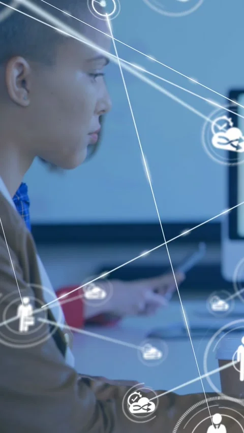 Vertical video: Camera pullback, worker focusing on screen while nodes expanding Stock Footage 333036514