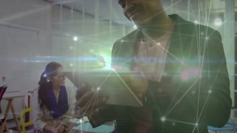 Vertical video: Camera pulling back, standing man in blazer tapping tablet at Stock Footage 333631837