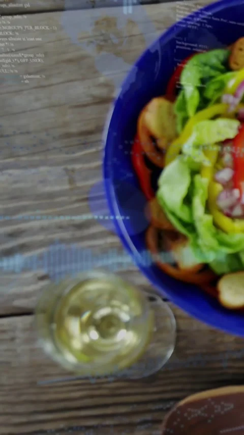 Vertical video: Camera pulling back, revealing salad bowl, blue overlay showing Stock Footage 334550221