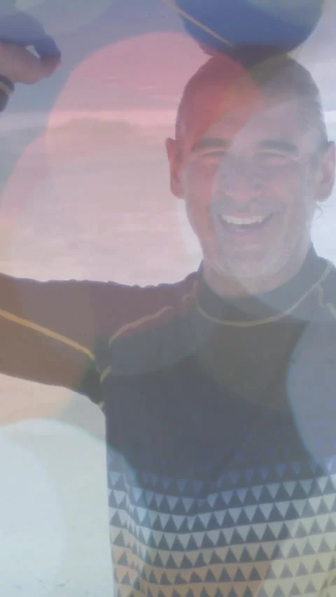 Vertical video: Camera rolling as man raising blue ball by sea lens flare over Stock Footage 329840618