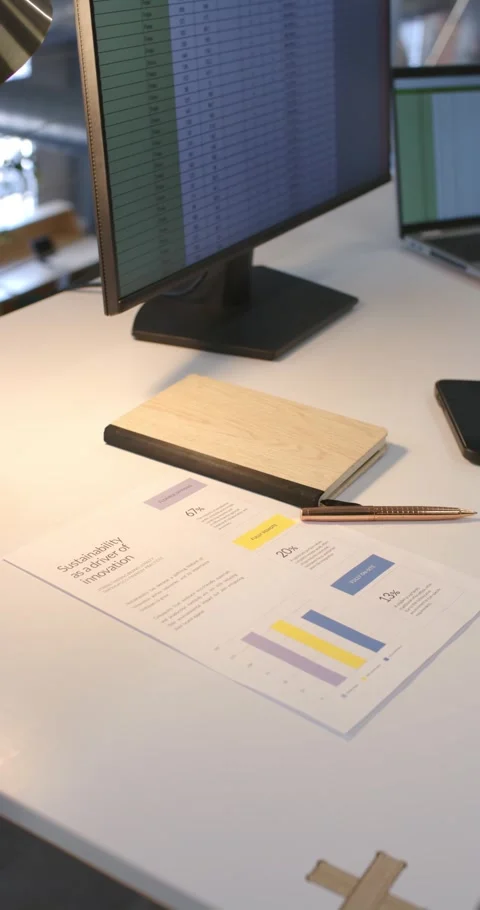 Vertical video: Camera shifting and zooming to reveal monitor and notebook at Stock Footage 341030608