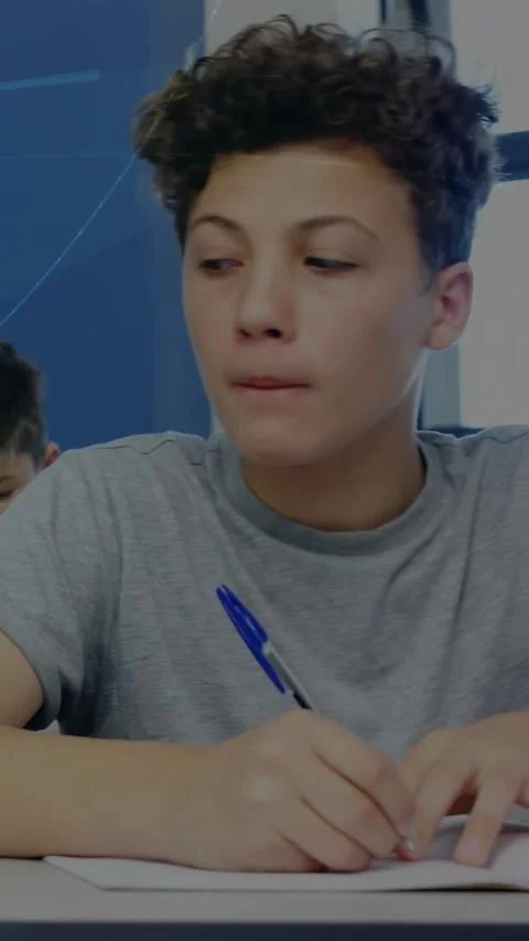 Vertical video: Camera shifting close to teen boy writing with blue pen, Stock Footage 330395429