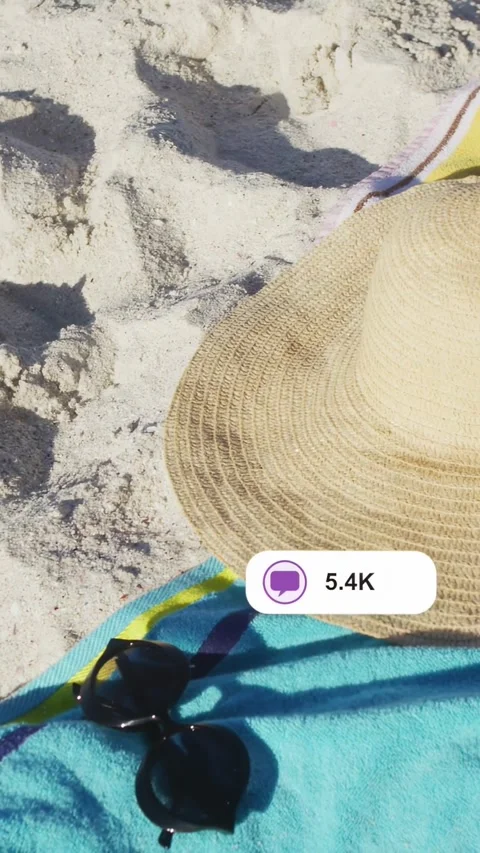 Vertical video: Camera shifting, hat on towel, shades beside, UI bubbles popping Stock Footage 333862437
