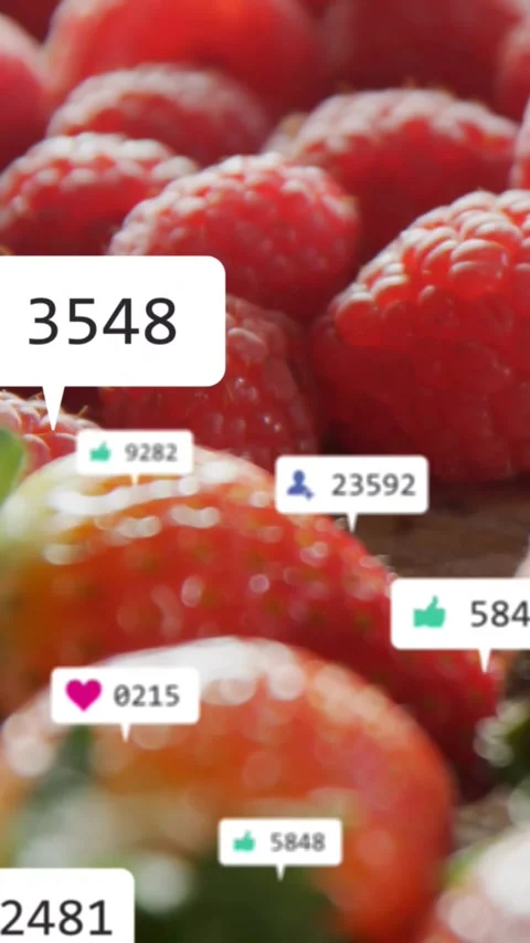 Vertical video: Camera shifting revealing berries with floating likes popping Stock Footage 331738913