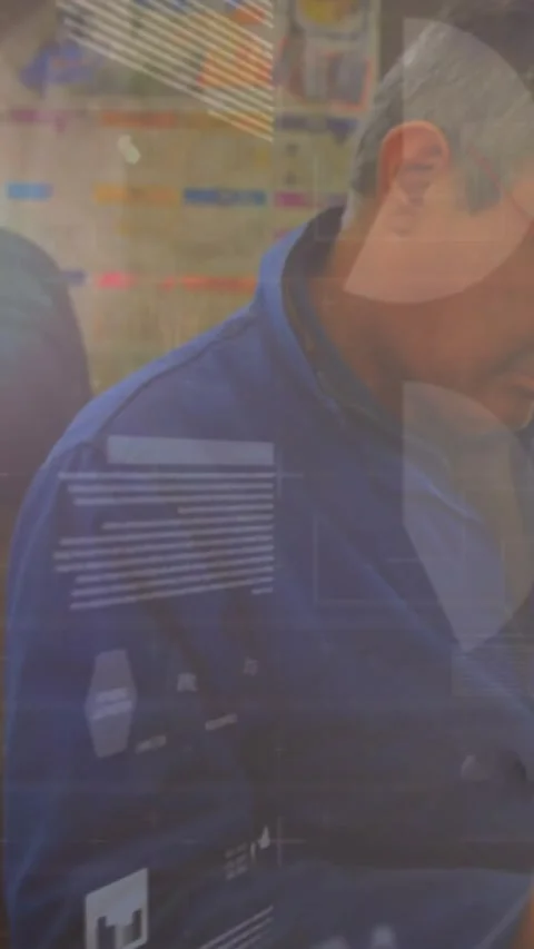 Vertical video: Camera shifting senior worker leaning inspecting parts HUD Stock Footage 331703098