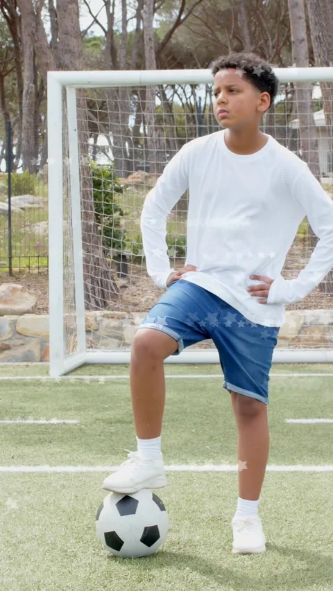 Vertical video: Camera starting, boy balancing foot on soccer ball, scanning Stock Footage 334046898