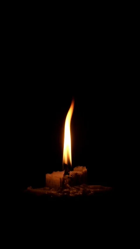 Vertical video of a candle burning in the darkness Stock Footage 336830738