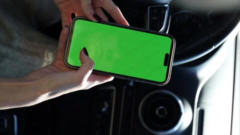 Vertical video Capturing Moments: A Hand Holds a Smartphone with a Green Screen Stock Footage 314460267