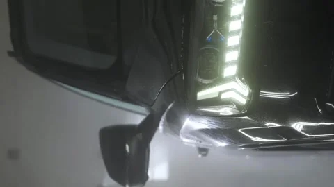 Vertical video. A car wash worker washes the driver's door of a black car. Video stock 244048664