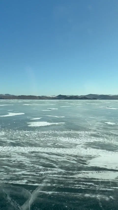 Vertical video from car window of auto driving on ice crossing to Olkhon Island Stock Footage 305462503