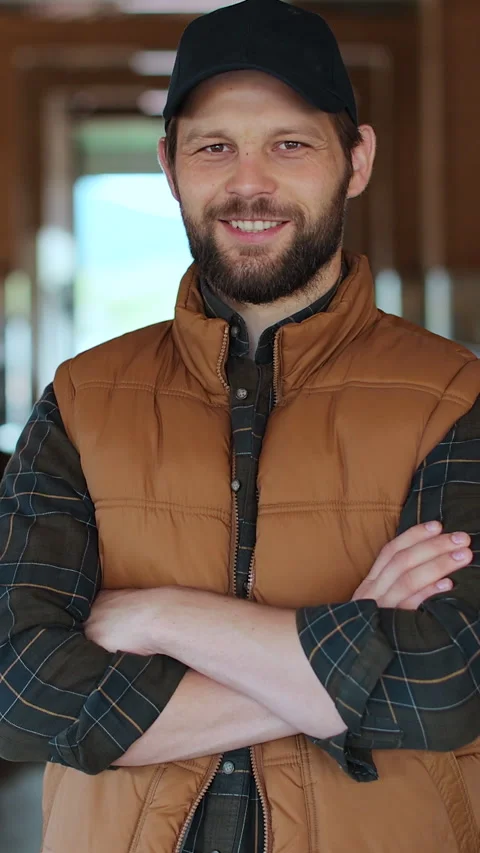 Vertical video. Caucasian man with beard owner of farm in orange Stock Footage 344629235