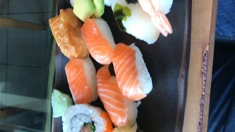 Vertical video Cellphone point of view sushi plate Stock Footage 113330853