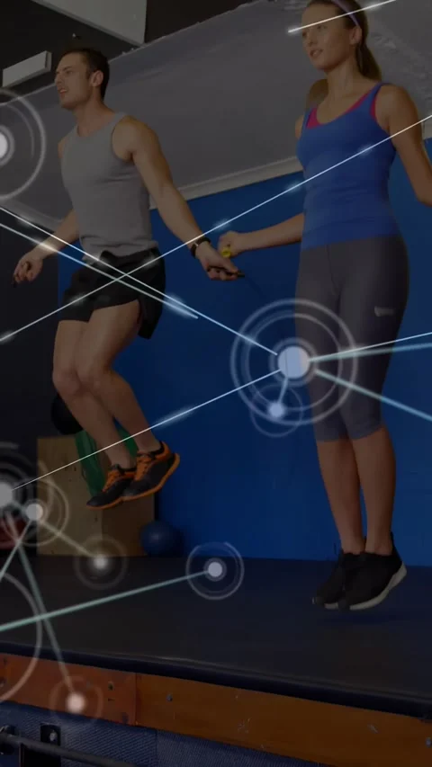 Vertical video: Central pair jumping rope on platform, jumps activating HUD 動画素材 330982385