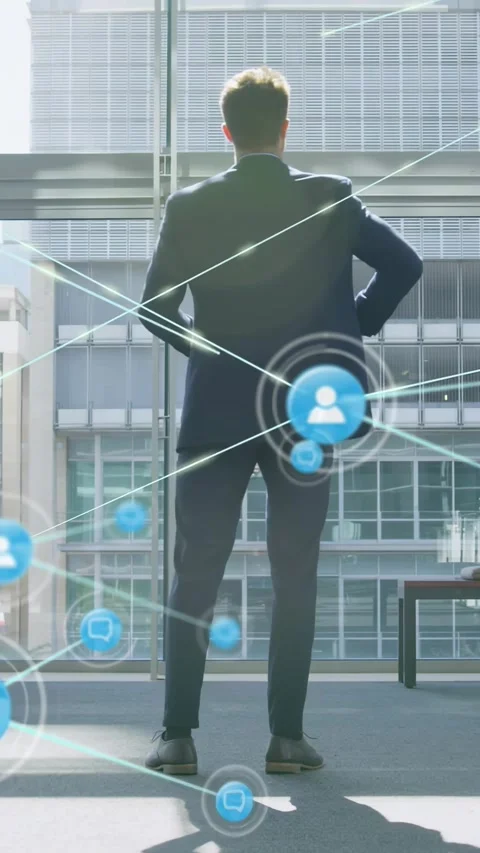 Vertical video: CEO walking to window sparking user icons around him, showing Stock Footage 329875990
