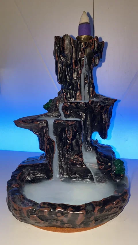 Vertical video of ceramic incense smoke fountain with led light background Stock Footage 221383390