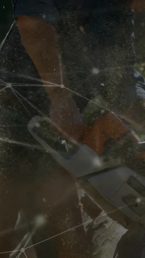 Vertical video: Chainsaw worker engaging saw cutting log for tree work, animated Stock Footage 332546825