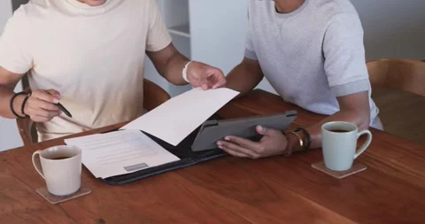 Vertical video: Checking docs opening folder, men pointing at tablet on wood Stock Footage 341468376