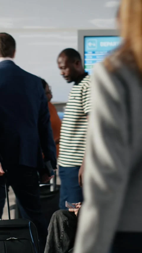 Vertical video Checking flight schedule, screen and man with woman in airport Video stock 334852158