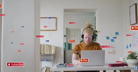 Vertical video: Checking laptop man in rust tee with headset at home, badges Stock Footage 333967680