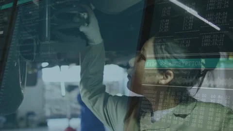 Vertical video: Checking tech in coat after lift gloved turning bolts under car Stock Footage 331713500