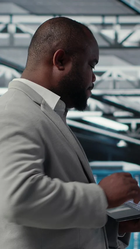 Vertical video Cheerful data center system administrator reviews code for Stock Footage 311488952